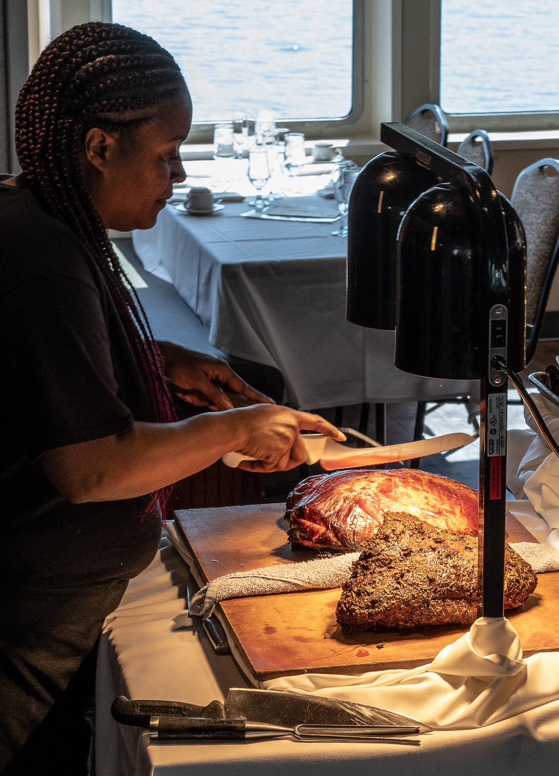 Woman at carving station on a boat