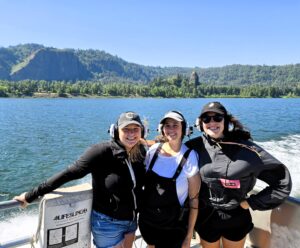 three women on back of a jet boat in the Columbia River Gorge