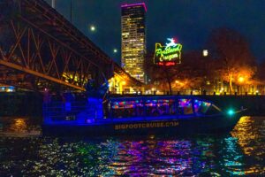 Explorer Jet boat at night in front of Portland Oregon sign during Christmas Ship Parade