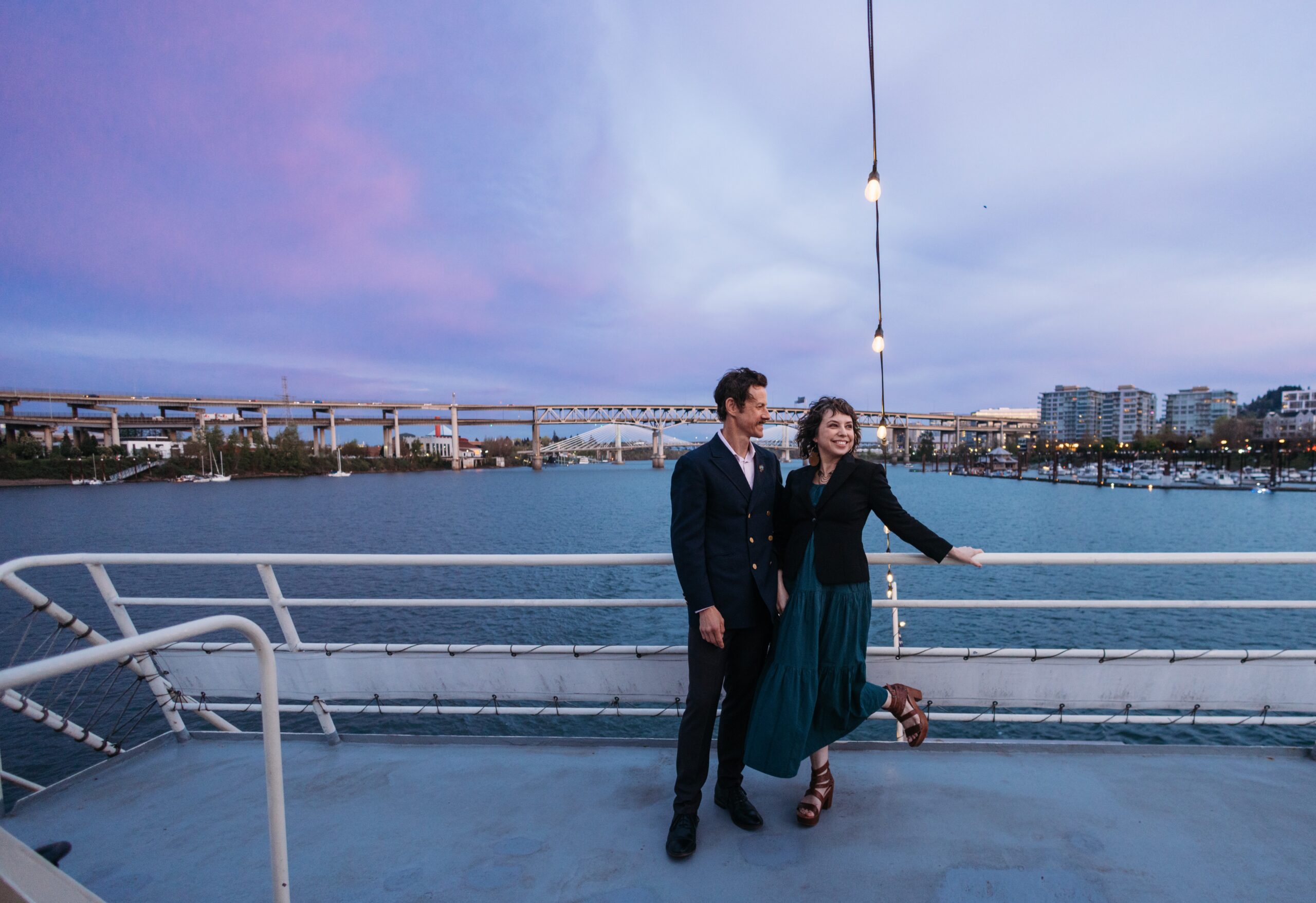 Couple on aft of yacht during sunset